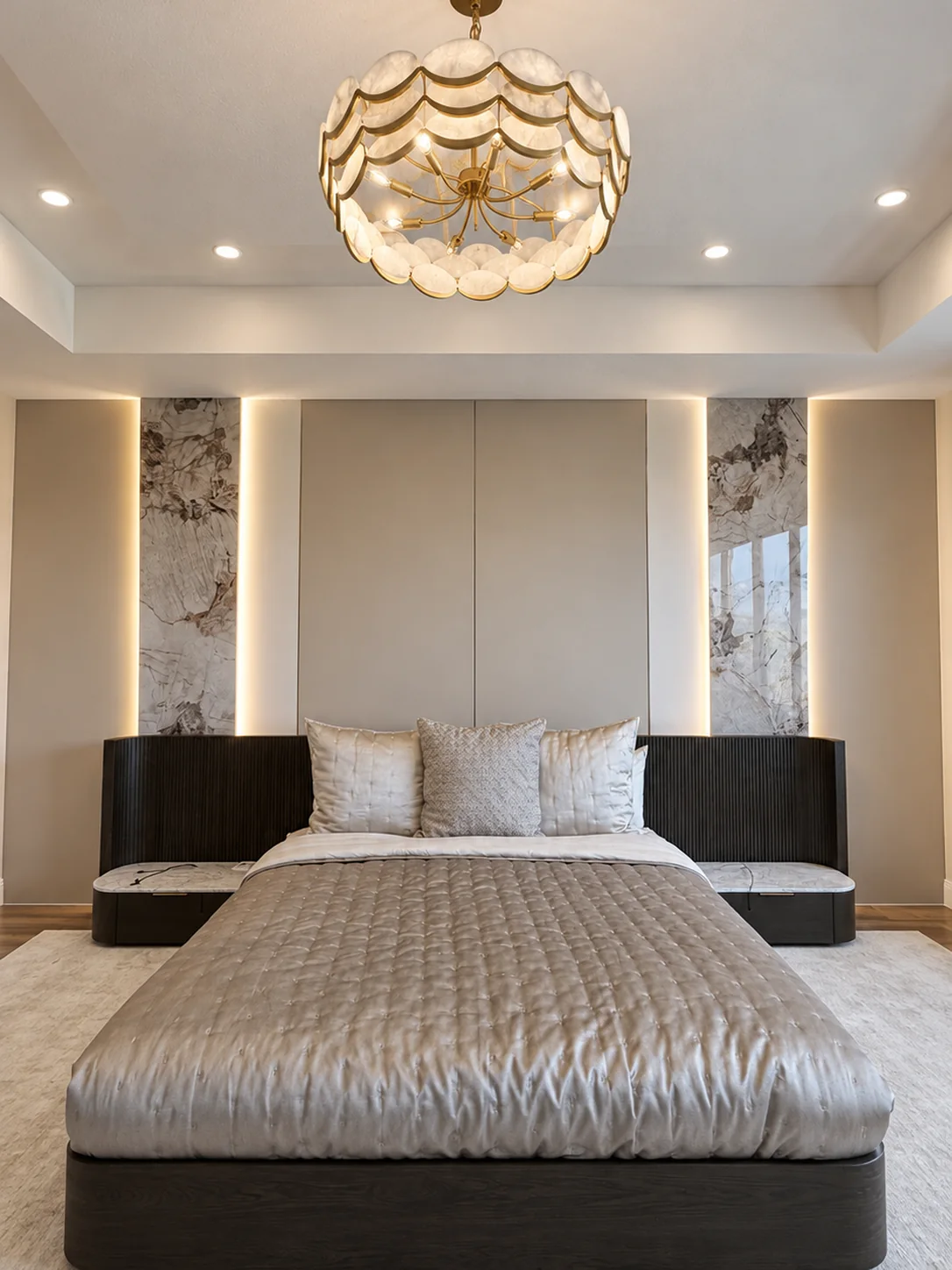 The same bedroom finished: upholstered headboard wall with book-matched porcelain panels and LED seams, chandelier — after