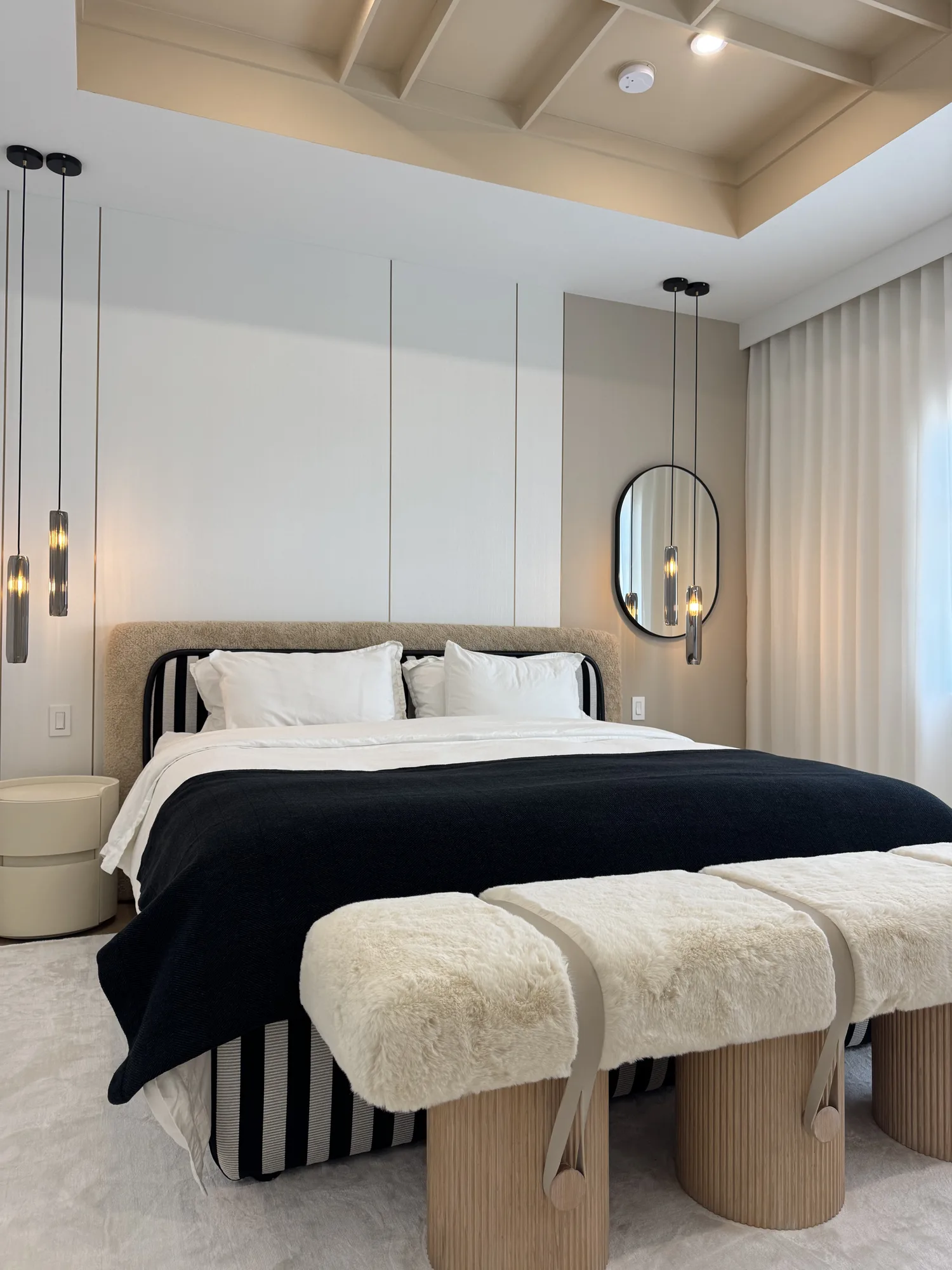 Bedroom wall with full-height flat panels behind the bed and pendant lights