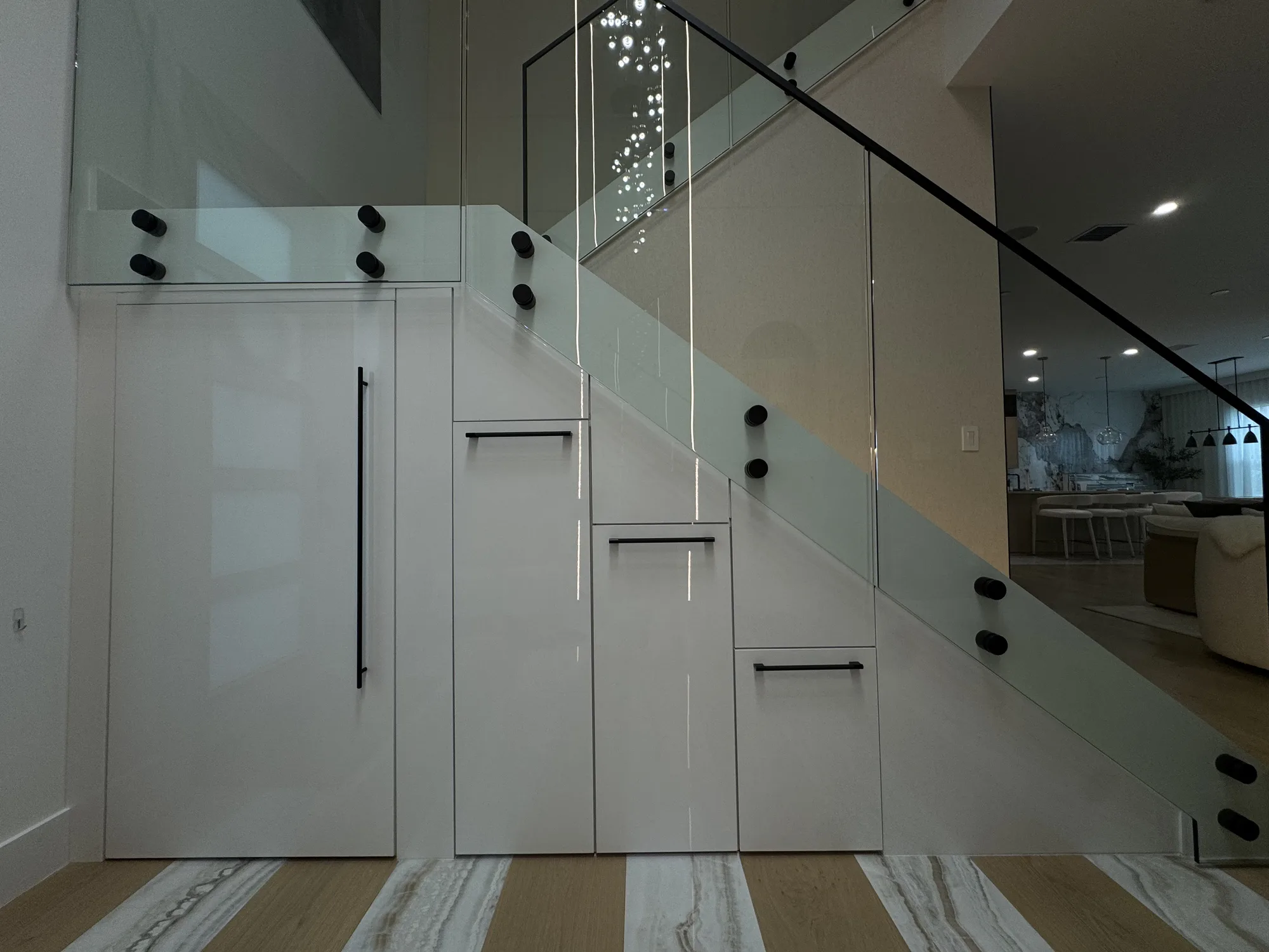 Handleless under-stair storage cabinets in white