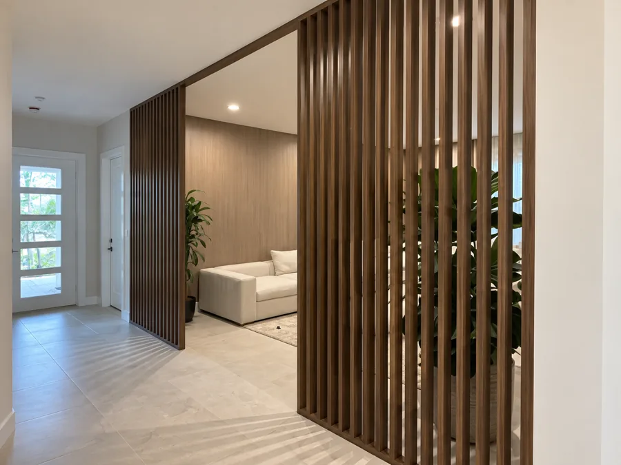 Floor-to-ceiling walnut slat room divider
